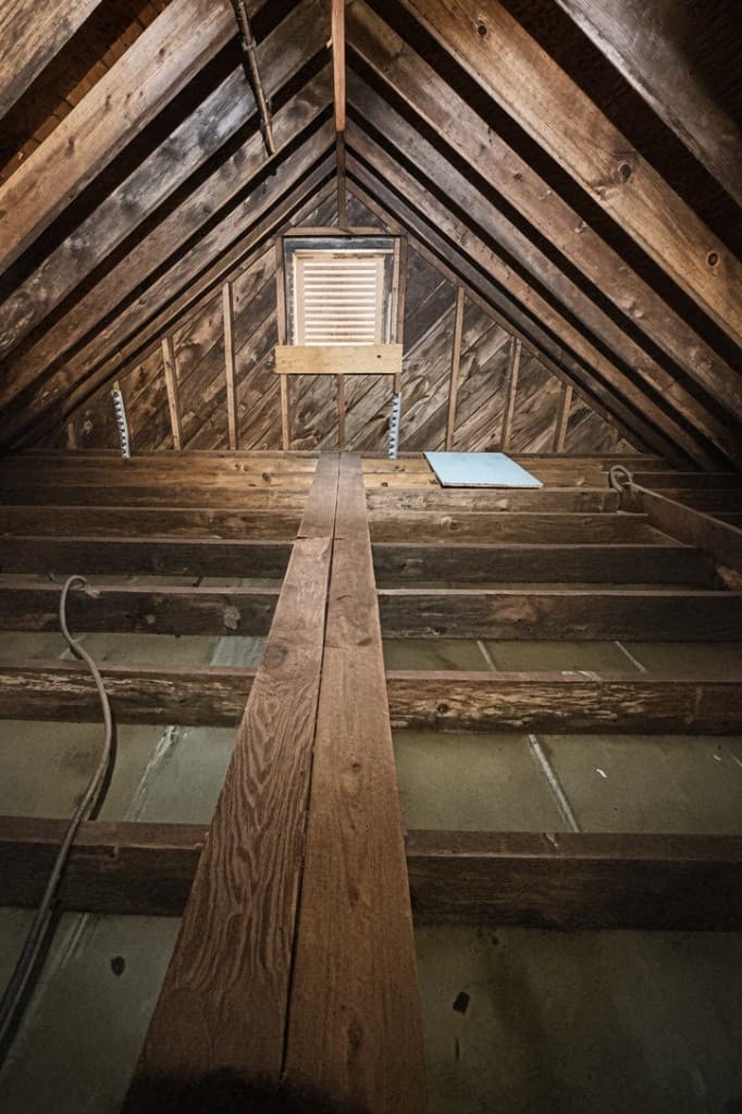 Attic cleared to bare joists after old insulation was removed