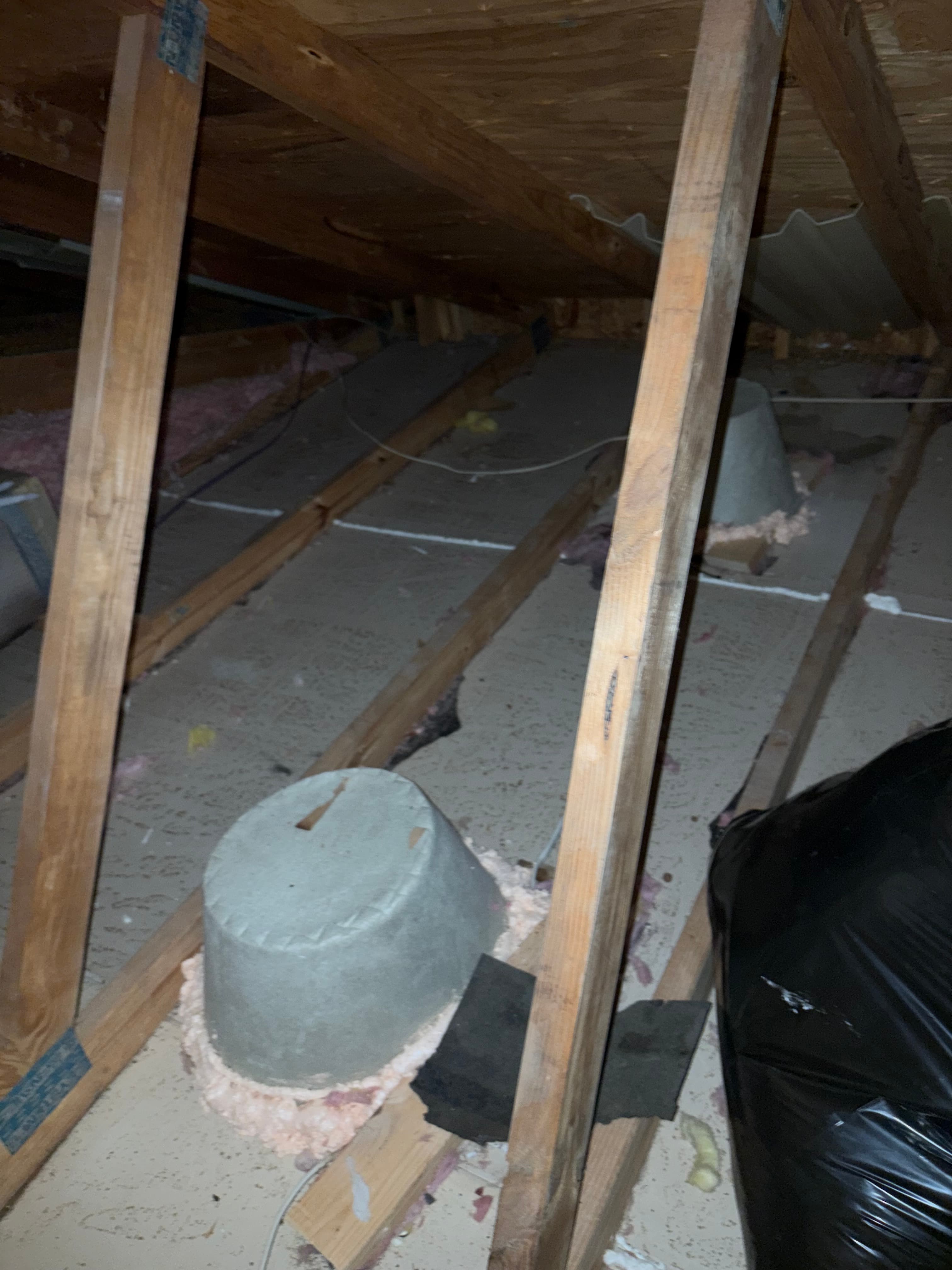 Old batt insulation sagging out of the floor joists in a crawl space