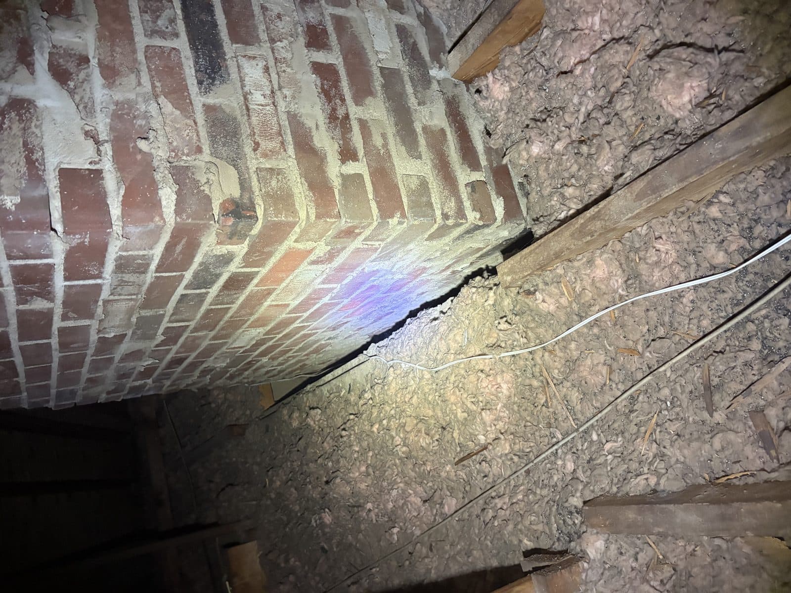 Gap where a chimney meets the framing — a major air-leak point