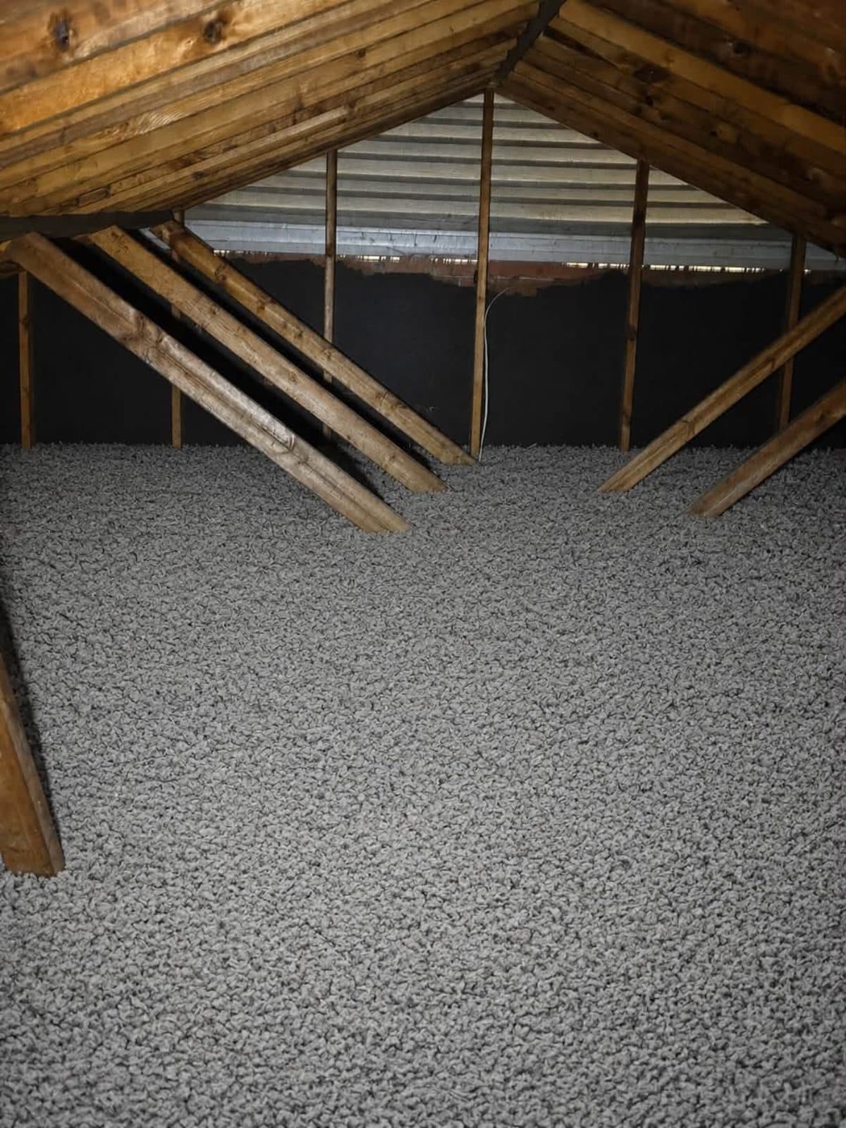 Thick, even layer of blown-in insulation covering an attic floor